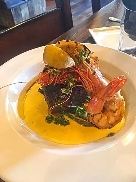MORE THAN APPS: What goes into Mason Bar’s new Cioppino? Well, to start: Four little neck clams, three snow crab claws, a 5-ounce piece of tooth fish, four jumbo head-on tiger prawns, tomato white wine fumet, fried leeks, garlic, shallots, saffron oil, and grilled baguette. - PHOTO COURTESY OF MASON BAR