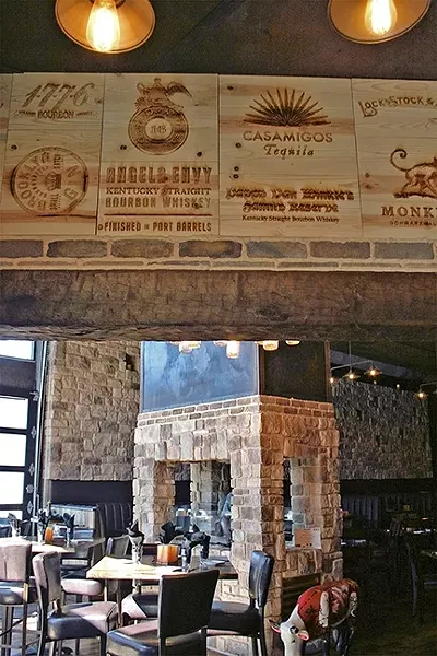 DINNER HOUR: Mason Bar in Village of Arroyo Grande has expanded its seating to encompass former neighboring restaurant, Robert’s. Complete with reclaimed wood, stone walls, and a sleek, modern fireplace, these renovations have upped the bar’s reputation from a swanky place to sip craft cocktails and nibble on apps to a legit dinner spot. - PHOTO BY HAYLEY THOMAS CAIN
