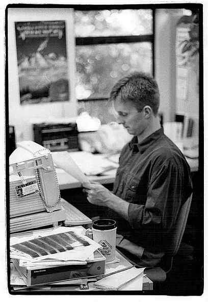 WORKING HARD?: A young Steven T. Jones looks over a document at his 'New Times' desk. - FILE PHOTO