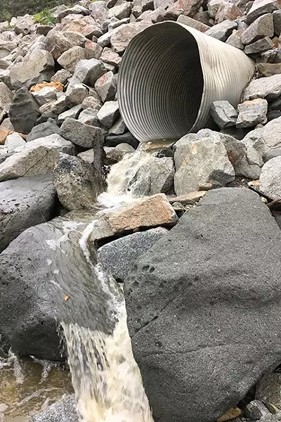 RUNNING WATER: A drainage pipe is rushing water to the sea at Olde Port dog beach on Jan. 8, where swaths of sand are washed away. - PHOTO BY GLEN STARKEY