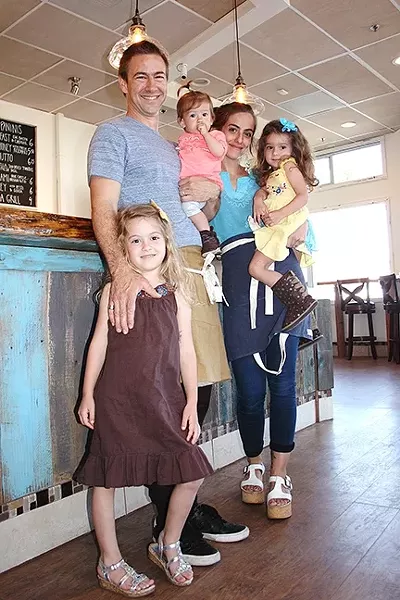 BUSY BEES: Red Bee Coffee owners Crosby and Miria Moreton stop for a coffee break with daughters Eliya, 5; Levia, 3; and Talya, 1. - PHOTO BY HAYLEY THOMAS CAIN