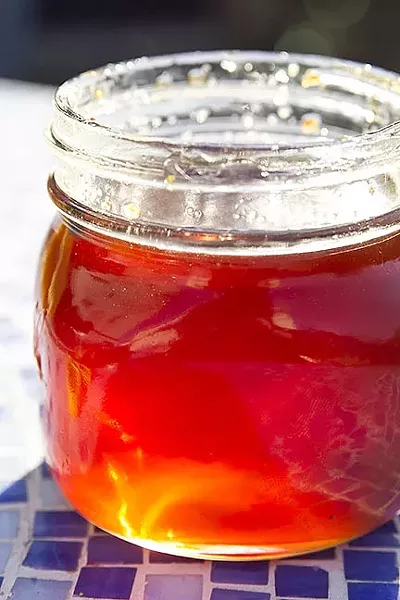 WHERE YOU BEEN?: Wondering where a honeybee has been? Well, depending on the hue and taste of a hive’s honey, you can sometimes guess exactly what kinds of flowers have come into play. Pictured: coastal Morro Bay honey featuring fiery bottlebrush nectar. - PHOTO BY JAYSON MELLOM