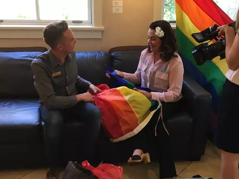 VANDALIZED: SLO Mayor Heidi Harmon talks with Ryan Duclos, president of SLO County’s Gay and Lesbian Alliance, after an unknown vandal set fire to a pride flag outside her home May 31. - PHOTO COURTESY OF ELLEN STURTZ
