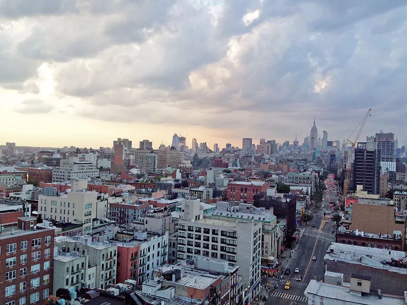 ROOFTOP SUNSET Looking out from the 18th floor of a hotel in China Town, the Empire State Building towers over the cityscape. Watching the sunset with a full view of Manhatten was so surreal and cool. - PHOTO BY PETER JOHNSON
