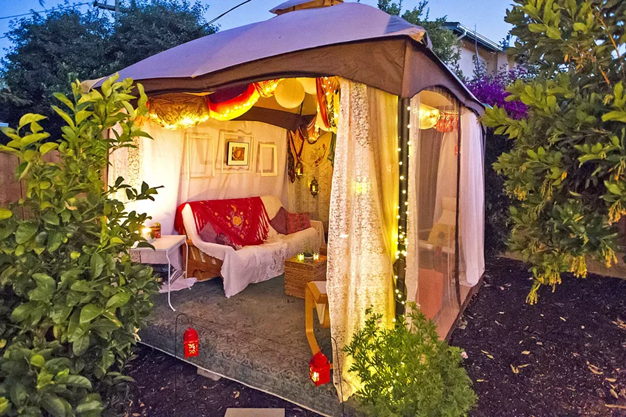 BEAUTY ON A BUDGET Sarah and Evan Goldhahn's SLO Town rental features a 10-by-12-foot deck Evan built with a friend, a store-bought gazebo, and décor by Sarah sourced from Craigslist, consignment stores, and collecting. - PHOTO BY JAYSON MELLOM