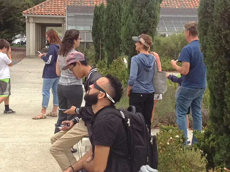 TOTAL ECLIPSE An overcast sky didn't stop people at Cuesta College in SLO from trying to view the total solar eclipse at the school's Bowen Observatory. - PHOTO BY CHRIS MCGUINNESS
