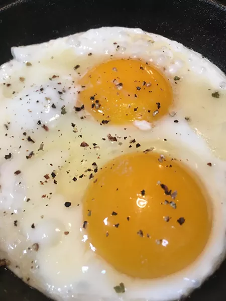 WAKEY WAKEY At Cain's house, a mini cast iron skillet—the perfect size for frying two eggs—sizzles with butter and fresh cracked black pepper. - PHOTOS BY HAYLEY THOMAS CAIN
