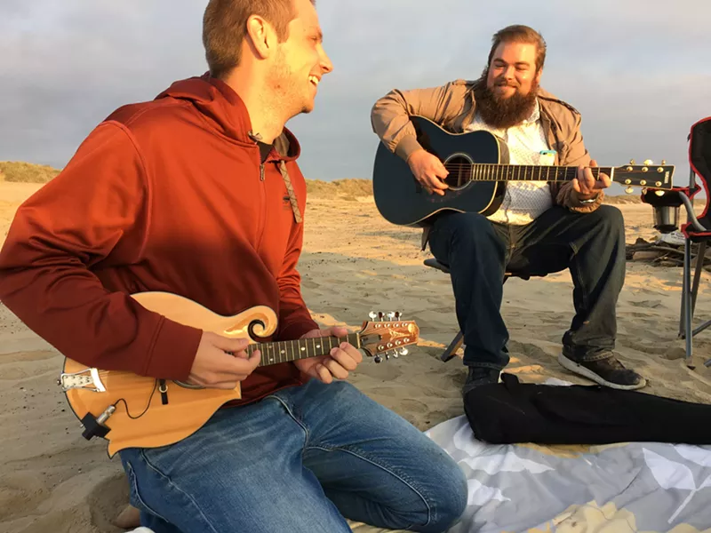 ENTERTAINMENT Who needs a radio when you have Joe Payne (right) and Peter Johnson (left) jamming out on guitar and mandolin. - PHOTO BY KAREN GARCIA