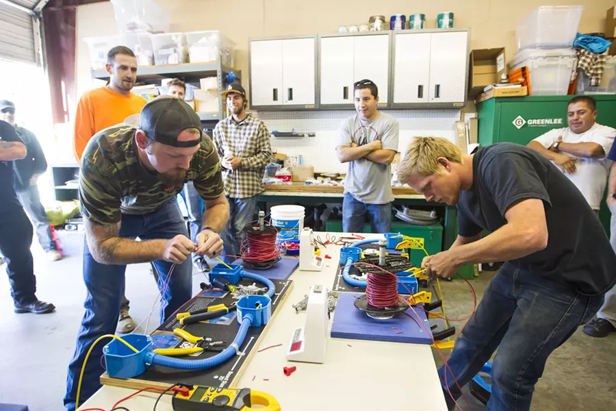BROTHERHOOD Members of the International Brotherhood of Electrical Workers Local 639 show off their skills before a union meeting on Sept. 24. - PHOTO BY JAYSON MELLOM