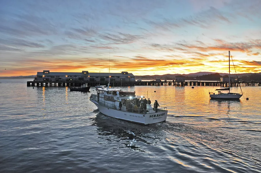 GOOD MORNING SUNSHINE A fishing tour heads out of the harbor at Fisherman's Wharf in Monterey early the Saturday morning after Thanksgiving. - PHOTO BY CAMILLIA LANHAM