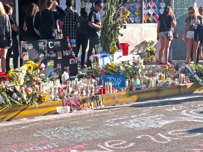 GRIEF ON DISPLAY Memorials took over the streets in Isla Vista after six people were stabbed and shot to death in May 2014. The massacre spurred the passage of new gun laws in California. - FILE PHOTO BY CHLOE RUCKER