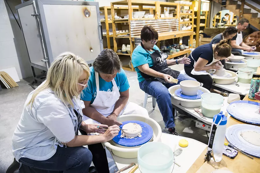 LEARN Susan Bass, owner of Pottery Coast in Grover Beach, teaches a student how to properly use the potter’s wheel during a class. - PHOTO BY JAYSON MELLOM
