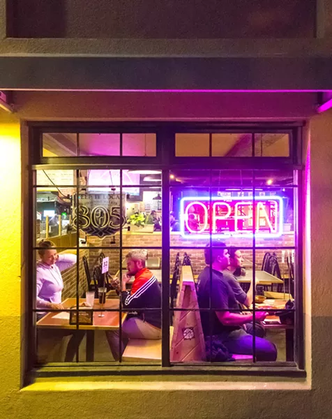 PIZZA TIME A late-night run to Woodstock's Pizza in downtown SLO is just the thing to do after downing one too many beers. - PHOTO BY JAYSON MELLOM
