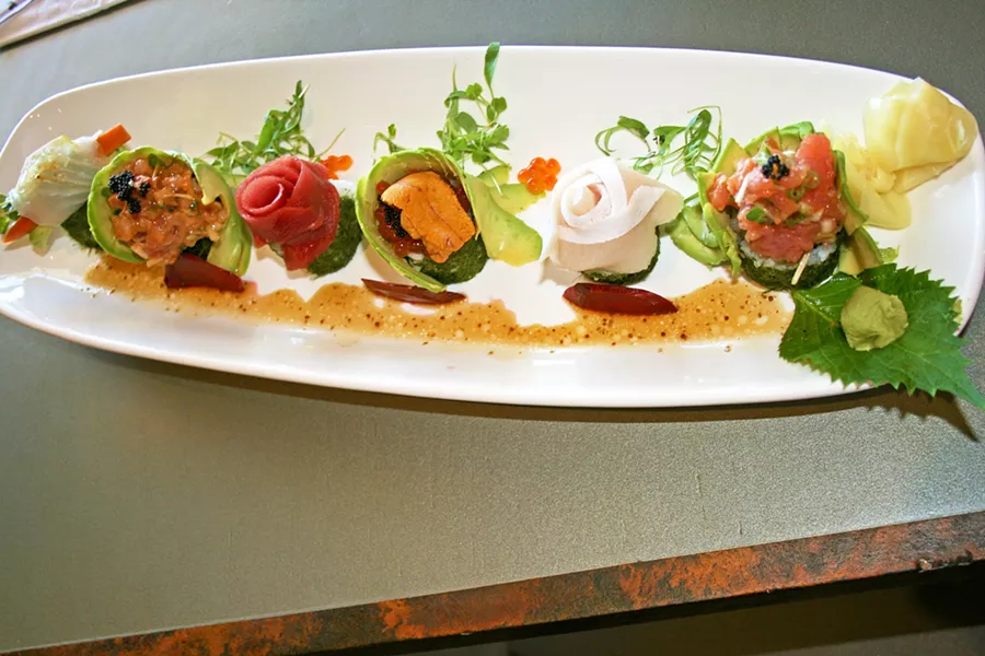 PACFIC DREAM Arigato Sushi's impressive Pacific Street roll features spicy tuna and cucumber within, plus a healthy helping of tuna, yellowtail, halibut, ikura (salmon roe), uni, and avocado throughout. - PHOTO BY HAYLEY THOMAS CAIN