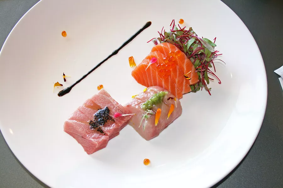 SAMPLE THE SEA The Arigato sashimi sampler is laden with thick slices of the freshest bluefin tuna, yellowtail, and salmon; topped with salty masago; and accompanied by tender microgreens and a drizzle of balsamic reduction. - PHOTO BY HAYLEY THOMAS CAIN