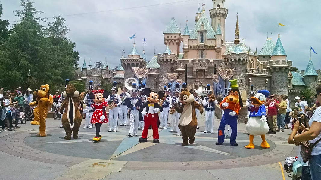THE GANG'S ALL HERE Mickey, Minnie, Donald, Goofy, Pluto, Chip, and Dale dance their tails off in front of the Sleeping Beauty Castle. - PHOTO BY CALEB WISEBLOOD