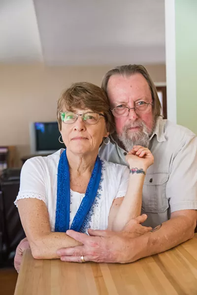 PAYING TRIBUTE Kim Lacey, of Atascadero, with her husband, Dan Grahm, in their home, shows her tattoo that she got in memory of her son Ty after he overdosed on heroin in 2016. - PHOTO BY JAYSON MELLOM