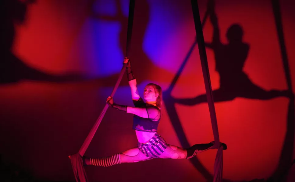 SEEING DOUBLE Aerialist Cheyenne Miller holds the splits on the aerial silks in preparation for the upcoming Halloween show, Welcome Stranger, at Levity Academy in SLO. - PHOTO COURTESY OF LEVITY ACADEMY