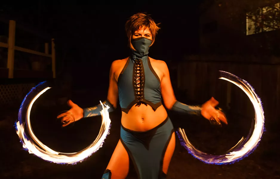RINGS OF LIGHT
Flow artist
Gwendolyn Hodgson from Ignite Fire Dance spins poi rings around her fingers. - PHOTO BY JAYSON MELLOM