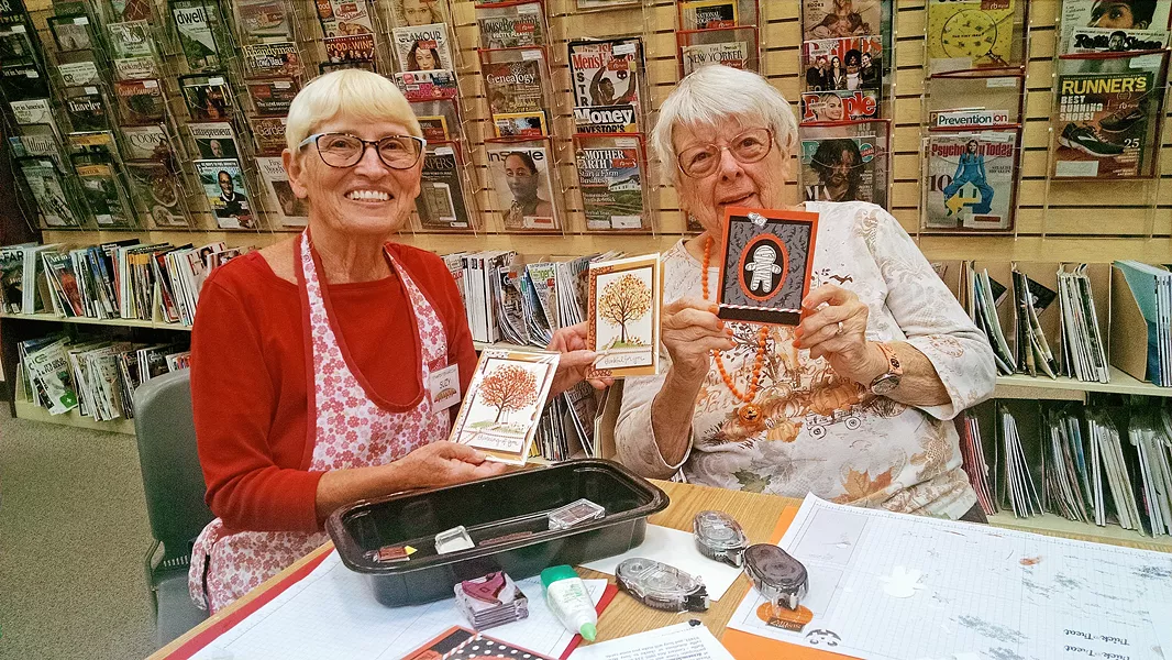 CARDCORE Instructor Suzy McBride (left) and workshop participant Snook Powers (right) show off their creations. - PHOTO BY CALEB WISEBLOOD