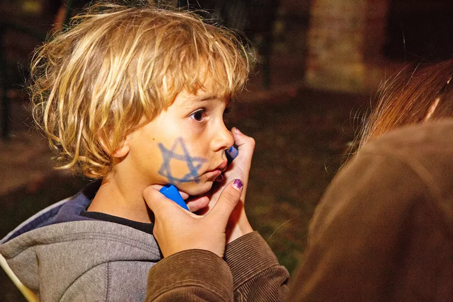 STAR A young child gets a Star of David drawn on his cheek on the first night of Hanukkah in 2017. - PHOTOS COURTESY OF THE JCC OF SLO