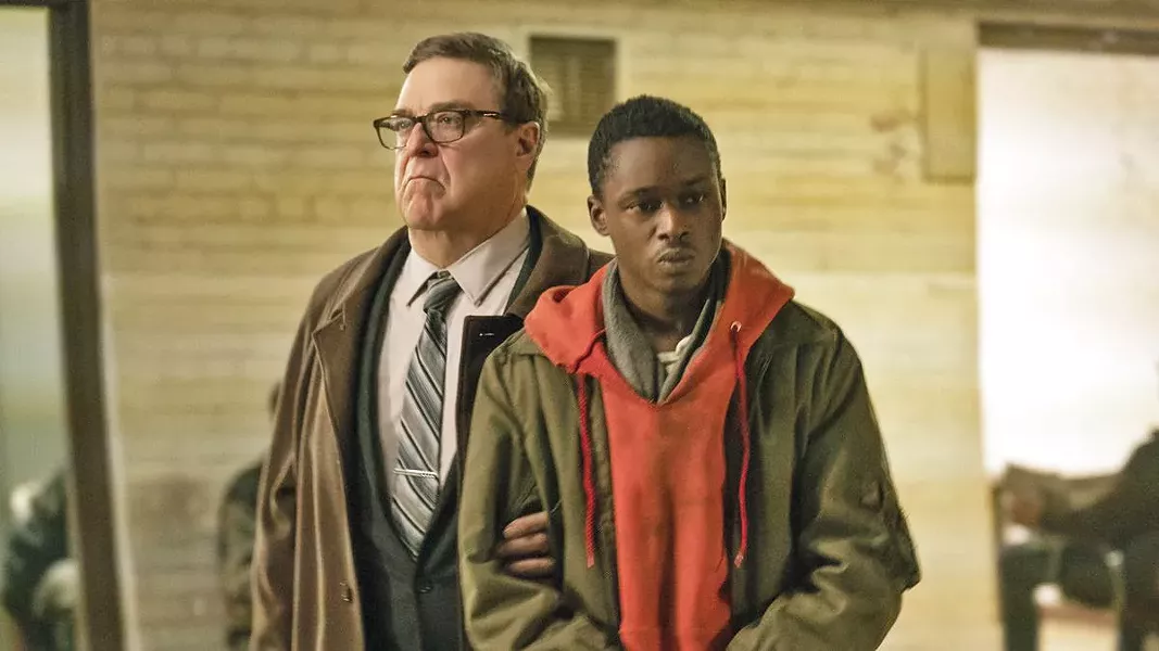 ENSLAVEMENT Ten years into an alien occupation, collaborator Officer Mulligan (John Goodman, left) believes Gabriel (Ashton Sanders), a young man whose brother was part of the alien resistance, may be a threat to his alien masters. - PHOTOS COURTESY OF DREAMWORKS
