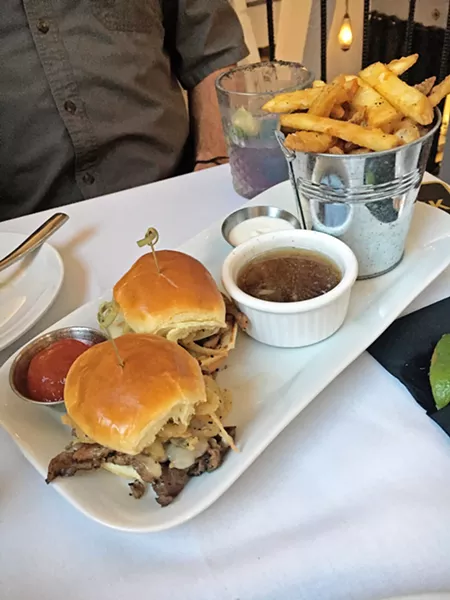 UPTOWN SLIDERS Don't you deserve Prime Rib in your sliders? These babies are dipped in au jus, topped with Swiss and onion straws, and served with your choice of fries. - PHOTOS BY BETH GIUFFRE