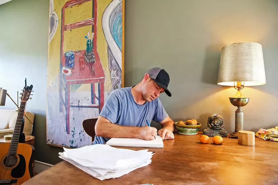 THE OBSERVER Commercial real estate agent by day, wood-shedding songwriter by night, Derek Senn hopes to start playing more live shows. - PHOTO BY JAYSON MELLOM