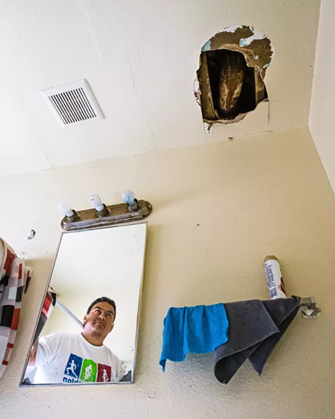 UNCOMFORTABLE In one unit of the Grand View Apartments in Paso Robles, a gaping hole above the bathroom sink often spills debris. - PHOTOS BY JAYSON MELLOM