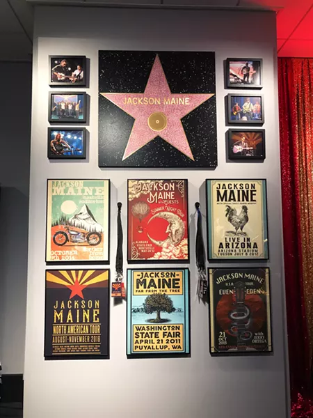 ALL YOU GOTTA DO IS TRUST ME Props from A Star Is Born (2018), including Jackson Maine's (Bradley Cooper) Hollywood Walk of Fame Star and fake concert posters, adorn a wall in the Script to Screen display. - PHOTOS BY GLEN STARKEY