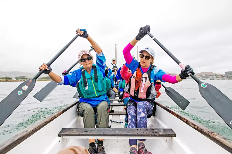 PADDLING TOGETHER Margaret Stone (left) and Missy Bullaro paddle with their teammates in Morro Bay at a Sept. 28 Central Coast Dragon Boating Association practice. - PHOTOS BY JAYSON MELLOM
