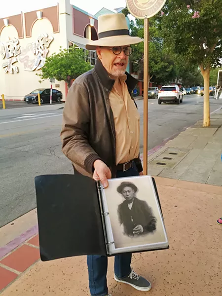AAAHHHH! LOUIS? Tour guide James Papp shows attendees a photo of Ah Louis, a Chinese-American banker and businessman who lived in San Luis Obispo during the late 19th and early 20th century. The Ah Louis Store was home to a murder and probably should be haunted, Papp said, but it isn't known to be. - PHOTOS BY KASEY BUBNASH