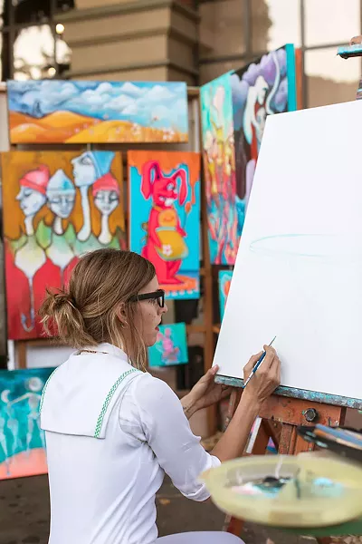 PAINTER'S ALLEY Local artist Jami Ray and her collective, Lamp Light Arts, practice live painting at venues around town, including occasionally at SLO's Downtown Farmers' Market. Here Ray paints on Garden Street. - PHOTO COURTESY OF IVAN DITSCHEINER