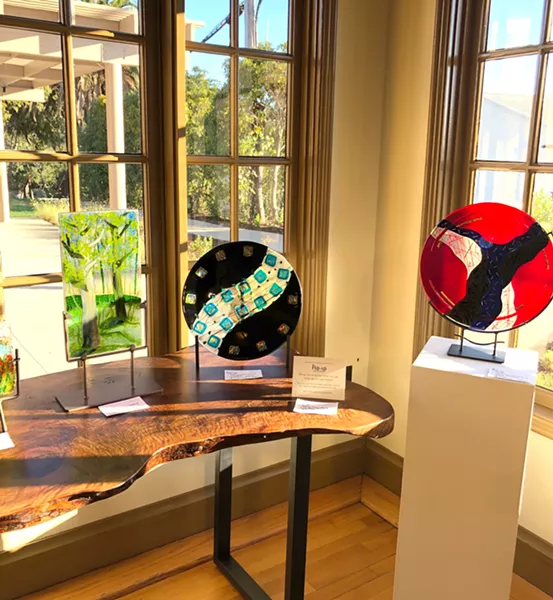 ENHANCED BY THE SPACE Colorful glass plates for sale at The Monday Club pop-up show were shown in their best light in a sunny corner of the historic building. - PHOTO BY MALEA MARTIN