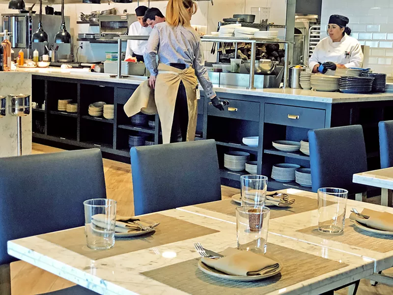 OPEN KITCHEN Chef James King, his two sous chefs, and the cooking staff work their magic in Somerset's open kitchen, which you can see from the main dining room. - PHOTO COURTESY OF NANCY UBER