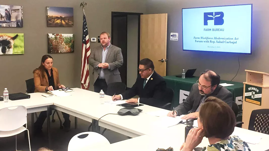 LABOR QUESTIONS Brent Burchett, (pictured standing) the executive director of the San Luis Obispo County Farm Bureau, introduces U.S. Congressman Salud Carbajal (D-Santa Barbara) to a group of local farmers and agriculture industry representatives during a Dec. 3 roundtable about modernizing the country's current guest-worker laws. - PHOTO BY WILLIAM D'URSO