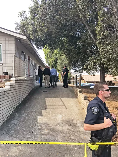 DEADLY FORCE SLO police officers and investigators stand around Regalia and Manford's driveway, minutes after one of their officers fired three rounds at a dog, which they say charged at him on Sept. 26. - PHOTO BY PETER JOHNSON