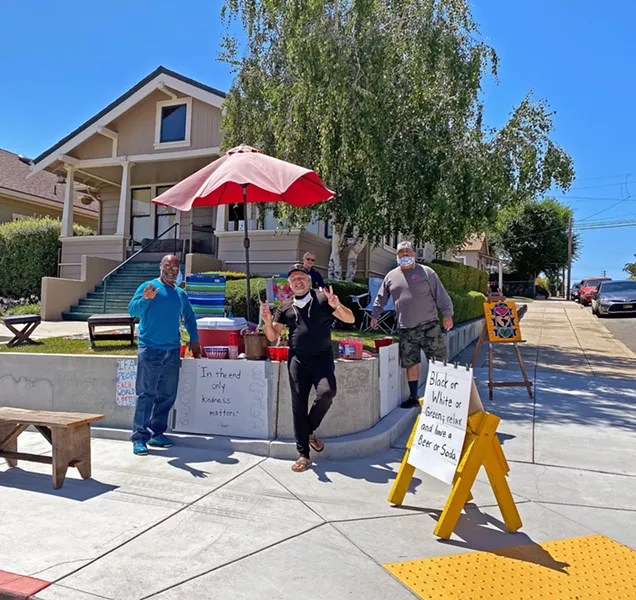 COMMUNITY David Bartholomew (right) and Dwayne Newman (left) got together to connect with their neighborhood and passersby over beer or soda and snacks. - PHOTO BY KAREN GARCIA