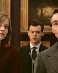 FORBIDDEN Marion (Emma Corrin); her husband, Tom (Harry Styles, center); and their friend Patrick (David Dawson) find their lives deeply damaged when the two men begin an affair in an era when homosexuality was illegal, in My Policeman, screening on Amazon Prime.