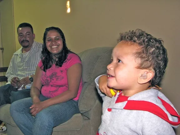 AN AMERICAN DREAM : Jose and Bibiana Ruiz are learning two new languages—ASL and English—to communicate with their deaf toddler, Angel. - PHOTO BY WENDY THIES SELL