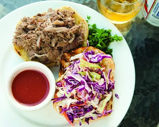 PULLED IT OFF : New Times staffer Glen Starkey and fiancée Anna Robertshaw made the sauce and coleslaw, while photographer Steve E. Miller made the pulled pork—all based on the winning Winemaker Cookoff Recipe from Still Water Winery. The final sandwich was spectacularly delicious and quite easy to make. - PHOTO BY STEVE E. MILLER