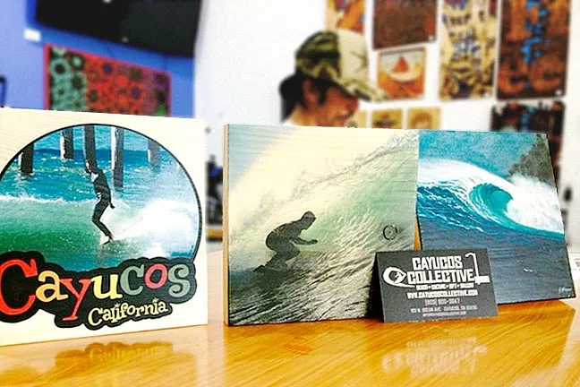 EARTHY: The Cayucos Collective can print any image on these natural wood canvases. Abe Toke is hard at work behind these wood prints. - PHOTO COURTESY OF CAYUCOS HOT SAUCE