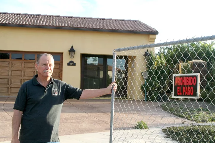 GATED COMMUNITY: Maria Vista Estates resident Aaron Adams bought his $700,000 home in 2007, thinking he’d found a place to retire but he now stands watch for vandals and burglars intent on raiding vacant homes in his neighborhood for appliances. - PHOTO BY JEREMY THOMAS