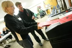 THE ACT : Poll worker Karen Poling helps Ken Pettit complete voting on Election Day. Few problems were reported at area polling places. - PHOTO BY STEVE E. MILLER