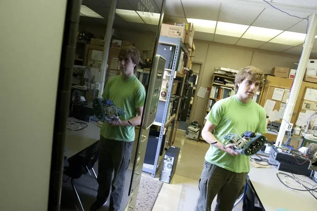 ROBOTIC GENIUS : Ryan Gelston, who plans on majoring in computer science in college, showed off his mini robot. - PHOTO BY STEVE E. MILLER