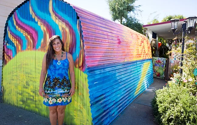THE COLOR OF CONTROVERSY: Pamela Dailey stands in front of her painted garage at the Santa Margarita Mobile Home Park. Park management told Dailey that she needs to repaint it or face eviction. - PHOTO BY KAORI FUNAHASHI