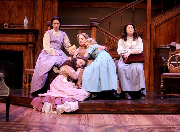 THE MARCH FAMILY: The four March sisters—Meg (Sarah Girard, upper left), Beth (Renee Wylder, lower left), Amy (Brittney Monroe, lap), and Jo, (Karin Hendricks, far right)—and their mother (Elizabeth Stuart, center), receive a letter from a faraway Mr. March in PCPA’s Little Women, the Broadway Musical. - PHOTO BY LUIS ESCOBAR, REFLECTIONS PHOTOGRAPHY STUDIO