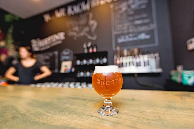 SWEET N SOUR: Libertine Pub’s new 9,000-square-foot brewing facility is home to a cozy-yet-edgy tasting room at 1234 Broad St. in Downtown SLO. Founder and head of brewing operations Tyler Clark aims to transform the space into a place for wild sour beers as well as cold brew coffee, food, and local artisanal goods. - PHOTO BY KAORI FUNAHASHI