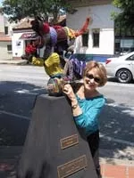 KNIT TAG APPRECIATOR : Tourists were seen taking photos with the Hey Diddle Diddle statue after it was blanketed during the New Arts Collective evening of knit tagging. - PHOTO BY MAYHEM