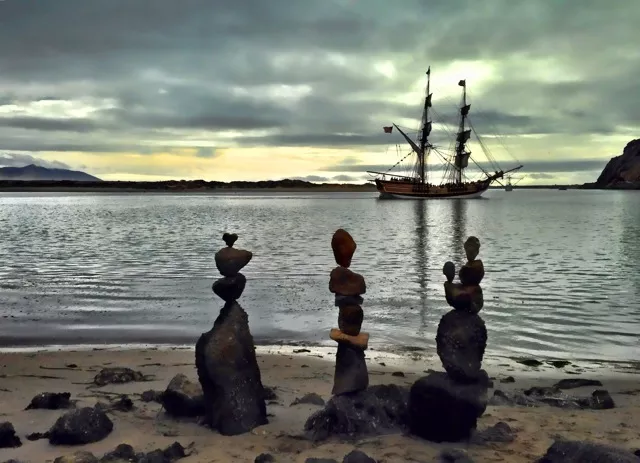 ROCK THE PLANK: When pirate ships came to Morro Bay, Clarke rushed to balance some nearby rocks before the ships vanished. - PHOTO COURTESY OF KATHY CLARKE